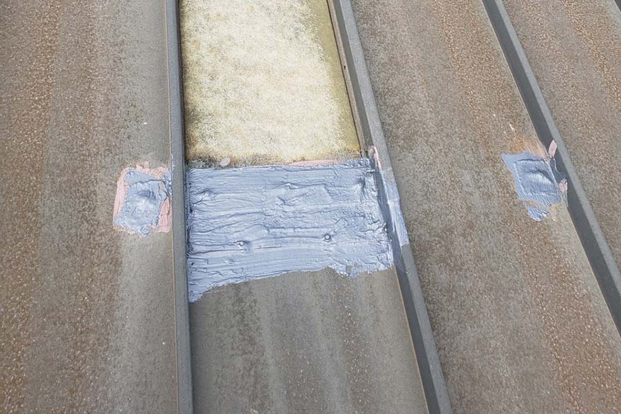 Roof coating application in progress — Transportation and logistics facility
