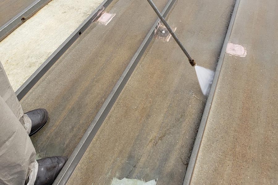 Roof coating application in progress — Transportation and logistics facility