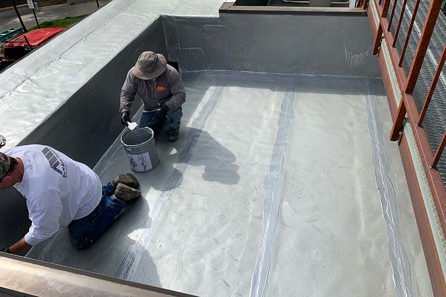 Roof coating application in progress — Police station (municipal)
