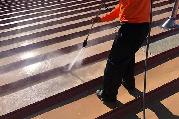 Roof coating application in progress — Volunteer fire station