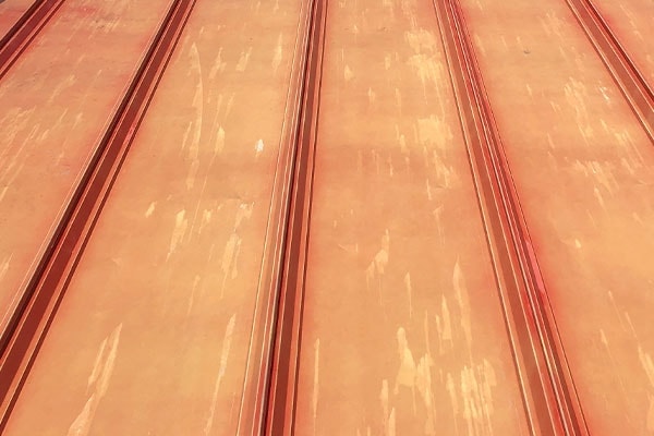 Roof coating application in progress — Volunteer fire station